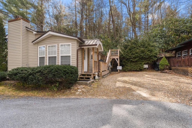 view of property exterior featuring a deck