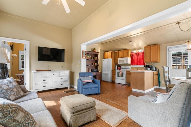 living room with ceiling fan, light hardwood / wood-style flooring, and ornamental molding