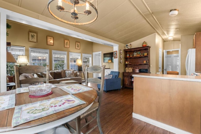 dining room with vaulted ceiling and dark hardwood / wood-style flooring