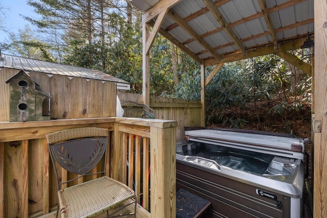 wooden deck with a hot tub