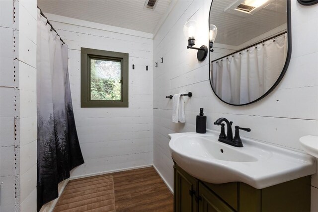 4860 Horse Cove Rd, Highlands, NC 28741 - bathroom featuring wood finished floors, vanity, curtained shower, and wooden walls