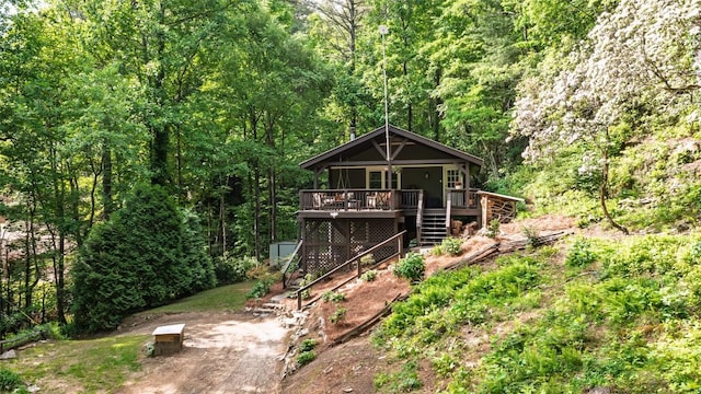 4860 Horse Cove Rd, Highlands, NC 28741 - view of front facade featuring stairway, a view of trees, and a wooden deck