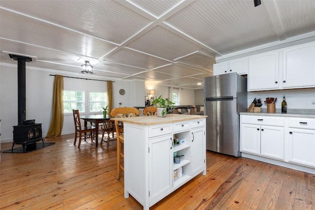 4860 Horse Cove Rd, Highlands, NC 28741 - kitchen with freestanding refrigerator, open shelves, white cabinets, light countertops, and light wood-style flooring