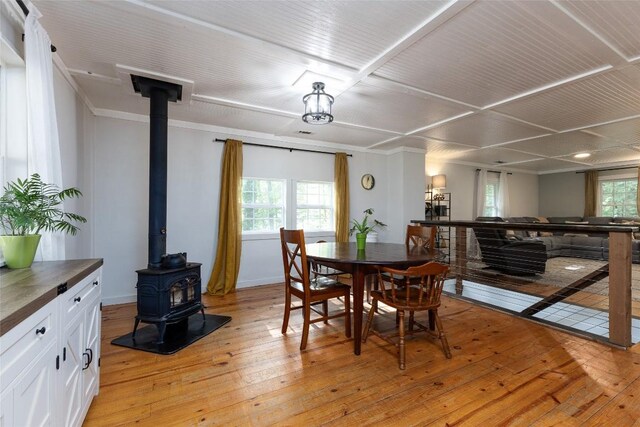 4860 Horse Cove Rd, Highlands, NC 28741 - dining room featuring a wood stove and light wood-style flooring