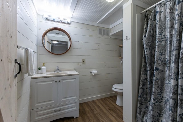 4860 Horse Cove Rd, Highlands, NC 28741 - bathroom with wood finished floors, toilet, vanity, wood walls, and curtained shower