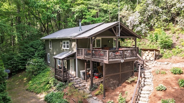 4860 Horse Cove Rd, Highlands, NC 28741 - back of property with a deck, metal roof, and a wooded view