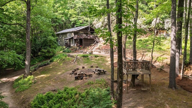 4860 Horse Cove Rd, Highlands, NC 28741 - view of yard with stairs, a deck, and a wooded view