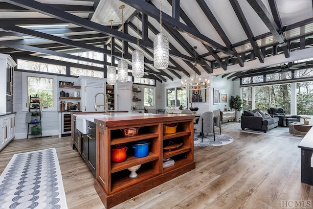 kitchen featuring high vaulted ceiling and light hardwood / wood-style floors