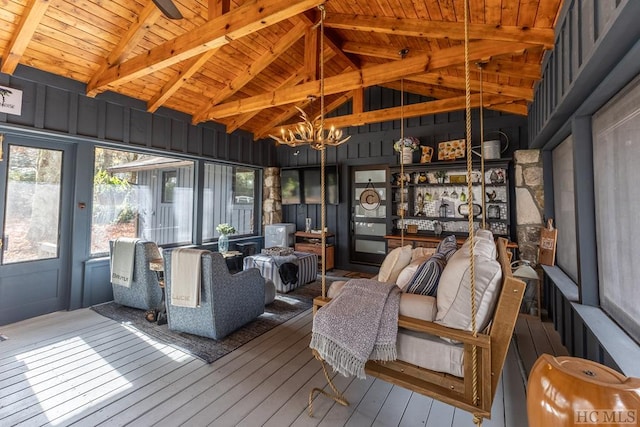 sunroom / solarium with vaulted ceiling with beams, wood ceiling, and a chandelier