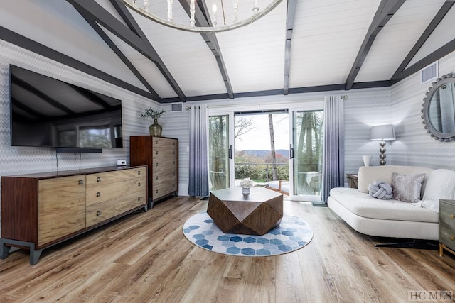 interior space featuring lofted ceiling with beams, an inviting chandelier, access to exterior, and hardwood / wood-style floors