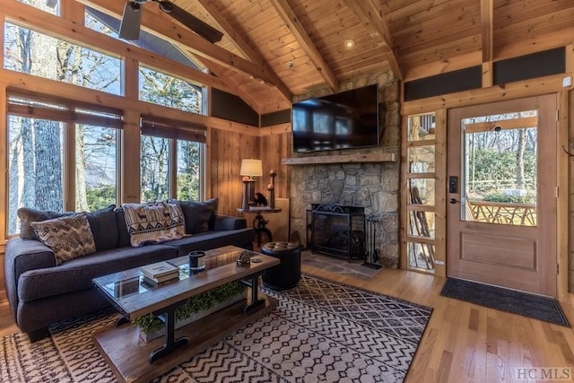 living room with wood ceiling, high vaulted ceiling, plenty of natural light, beam ceiling, and hardwood / wood-style floors