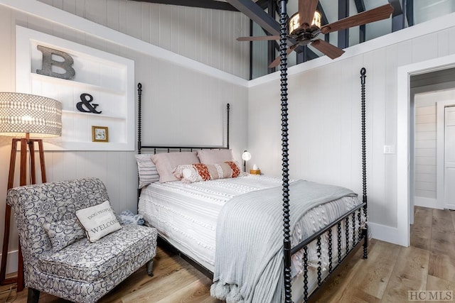 bedroom with hardwood / wood-style floors and high vaulted ceiling