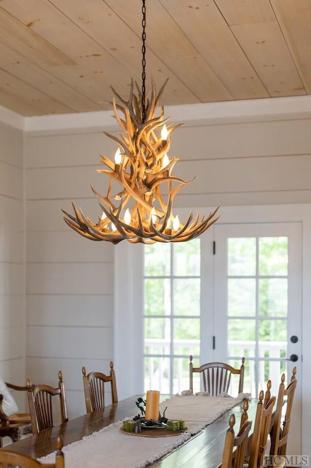 dining room with a notable chandelier and wooden ceiling