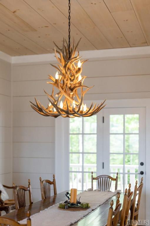 dining room with a chandelier and wood ceiling