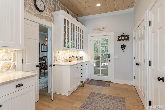 entryway with wood ceiling and light hardwood / wood-style flooring