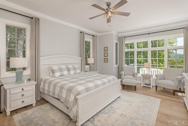 bedroom with crown molding, ceiling fan, and light hardwood / wood-style floors