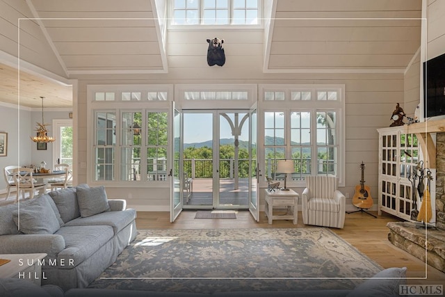 sunroom featuring a notable chandelier and vaulted ceiling