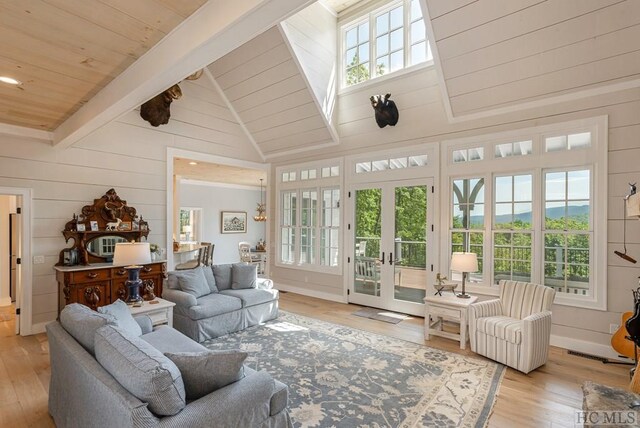 sunroom / solarium with french doors, wood ceiling, plenty of natural light, and lofted ceiling with beams