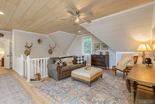 living room with lofted ceiling, hardwood / wood-style floors, wood ceiling, and wood walls