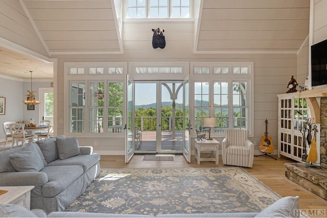 sunroom / solarium with lofted ceiling and a chandelier