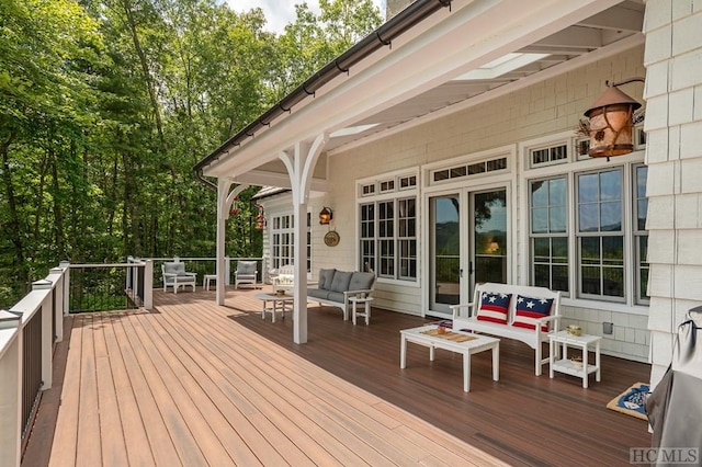 deck with an outdoor living space and french doors