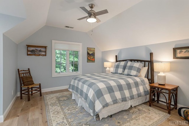 bedroom featuring ceiling fan, light hardwood / wood-style flooring, and lofted ceiling