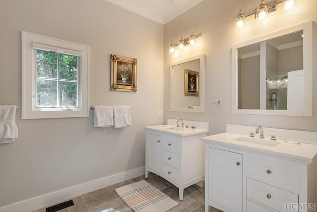 bathroom with a shower with door, vanity, tile patterned flooring, and crown molding