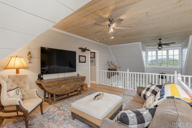 living room with vaulted ceiling, wood walls, wood-type flooring, ceiling fan, and wooden ceiling