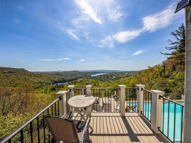 199 Mills Creek Point Rd, Lake Toxaway, NC 28747 - deck featuring a fenced in pool, a water view, and a wooded view