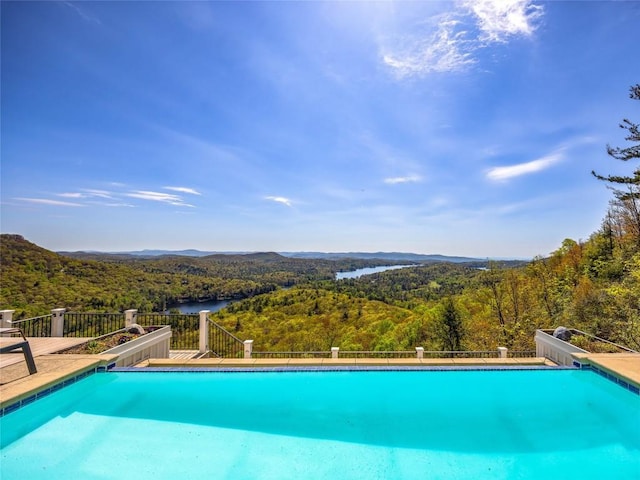 199 Mills Creek Point Rd, Lake Toxaway, NC 28747 - view of swimming pool featuring a forest view, a water slide, a mountain view, and a fenced in pool