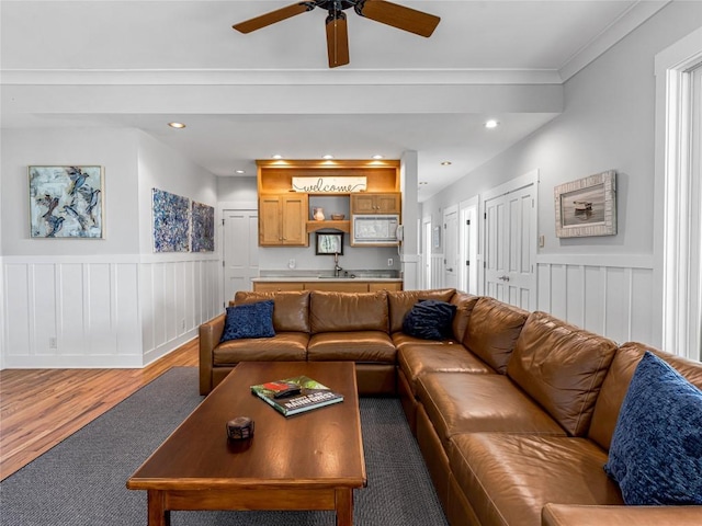 199 Mills Creek Point Rd, Lake Toxaway, NC 28747 - living area featuring a ceiling fan, light wood-type flooring, light carpet, and a wainscoted wall