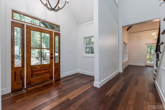 foyer with an inviting chandelier, plenty of natural light, and dark hardwood / wood-style floors