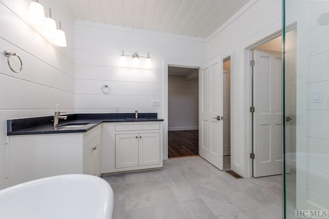 bathroom featuring vanity and a tub