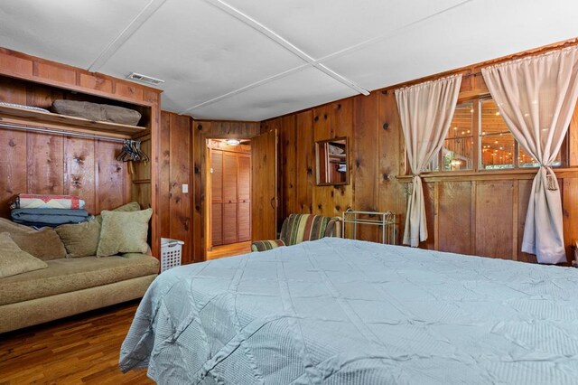 8378 Dillard Rd, Scaly Mountain, NC 28775 - bedroom featuring wooden walls and wood finished floors