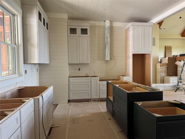 523 Broadview Dr, Highlands, NC 28741 - kitchen featuring plenty of natural light, wooden walls, white cabinets, glass insert cabinets, and wooden ceiling