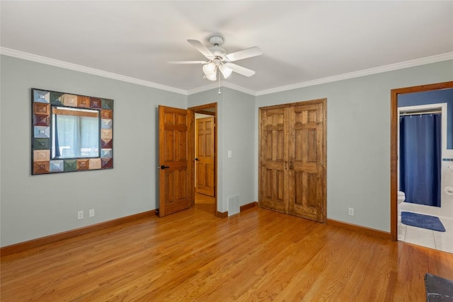 3398 Cullowhee Forest Rd, Cullowhee, NC 28723 - unfurnished bedroom featuring ornamental molding, light wood-style floors, a ceiling fan, and ensuite bath