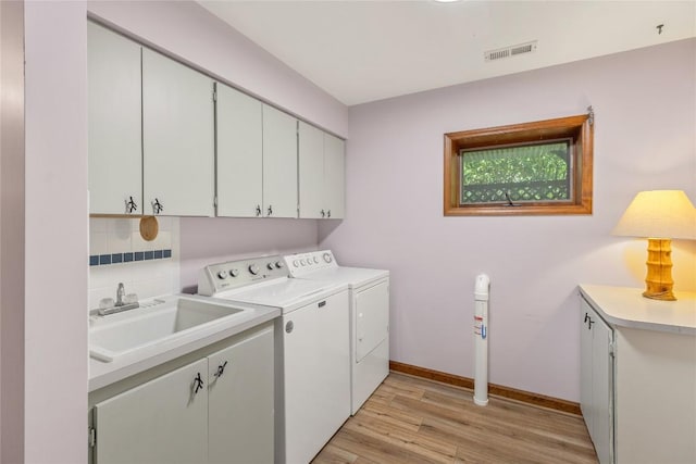 3398 Cullowhee Forest Rd, Cullowhee, NC 28723 - laundry room with cabinet space, washing machine and clothes dryer, and light wood finished floors