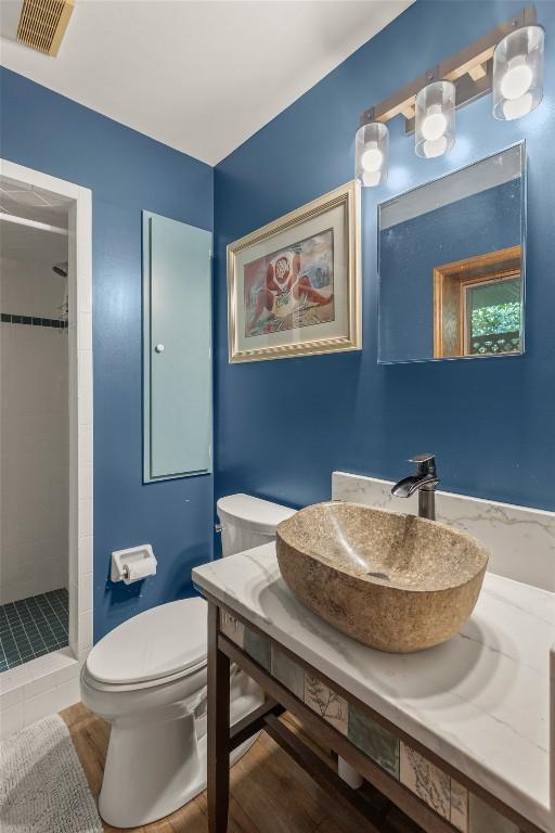 3398 Cullowhee Forest Rd, Cullowhee, NC 28723 - bathroom with a tile shower, vanity, and wood finished floors