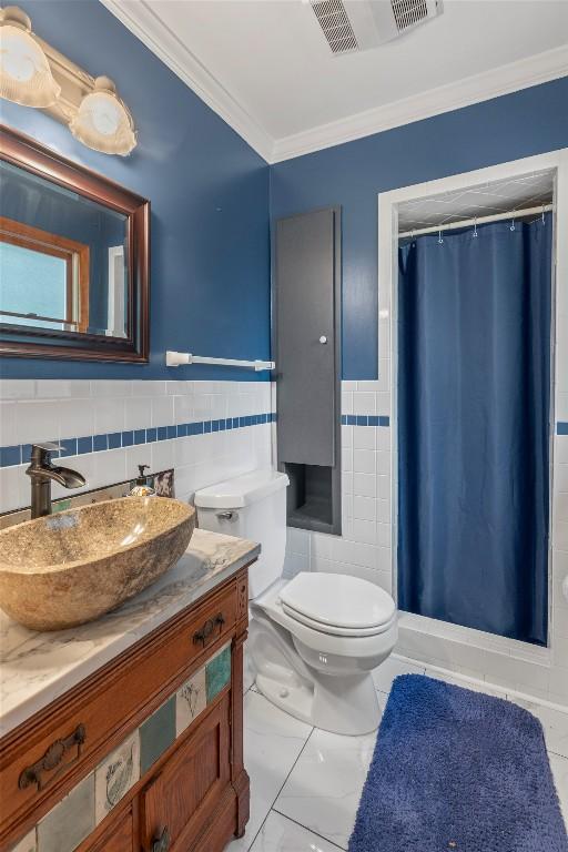 3398 Cullowhee Forest Rd, Cullowhee, NC 28723 - full bath featuring tile walls, vanity, ornamental molding, a shower with shower curtain, and a wainscoted wall