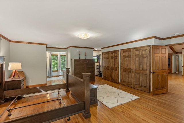 3398 Cullowhee Forest Rd, Cullowhee, NC 28723 - bedroom featuring wood finished floors, two closets, and ornamental molding