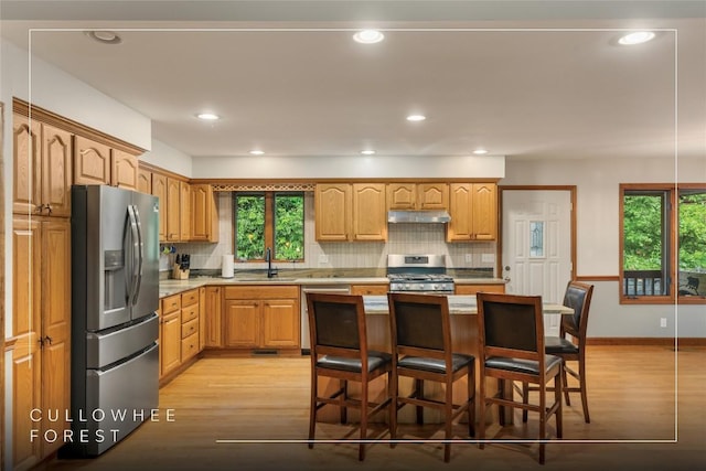 3398 Cullowhee Forest Rd, Cullowhee, NC 28723 - kitchen with appliances with stainless steel finishes, under cabinet range hood, light wood-type flooring, tasteful backsplash, and recessed lighting