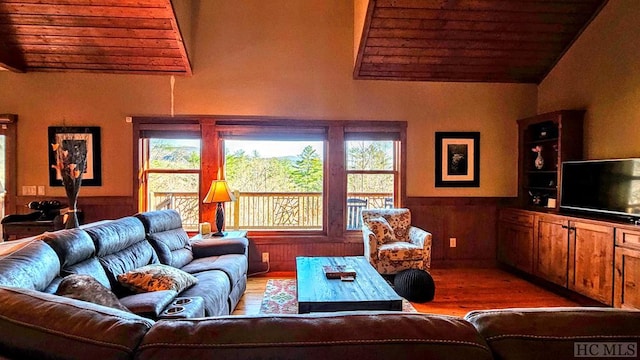 living room featuring wood ceiling, vaulted ceiling, and wood walls