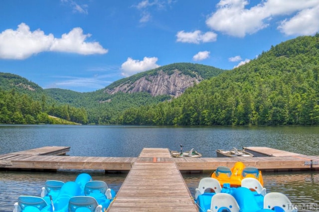 view of dock with a water and mountain view