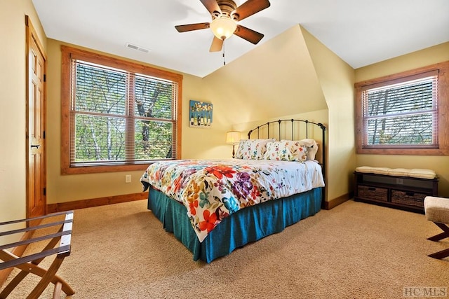 carpeted bedroom with vaulted ceiling and ceiling fan