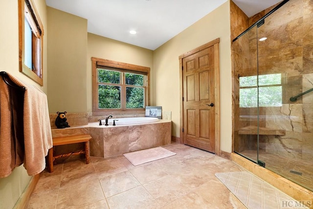 bathroom featuring independent shower and bath and tile patterned flooring