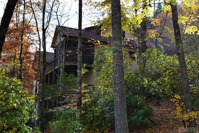 view of side of property with a sunroom