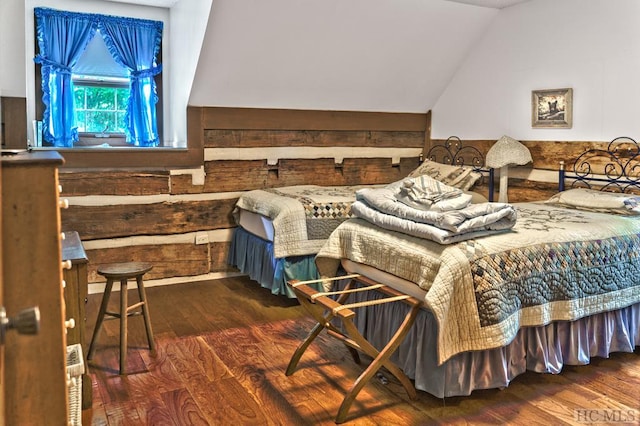 bedroom featuring vaulted ceiling and dark hardwood / wood-style flooring