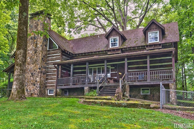 cabin with a sunroom and a front lawn