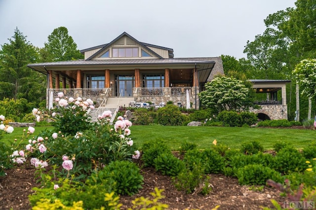 view of front of property with a front yard and covered porch