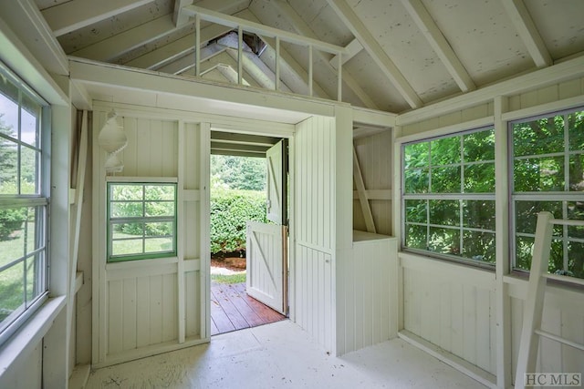 doorway to outside with vaulted ceiling